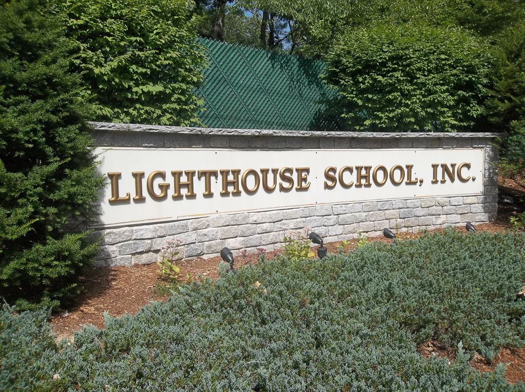 A sign that says lighthouse school inc. on it