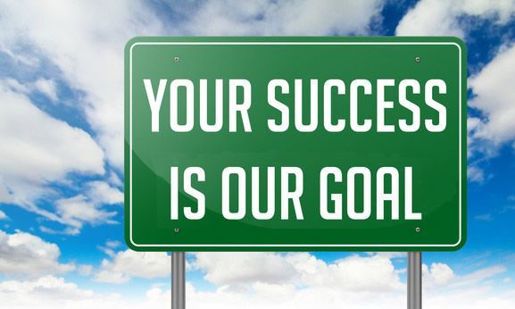 A green sign that says your success is our goal