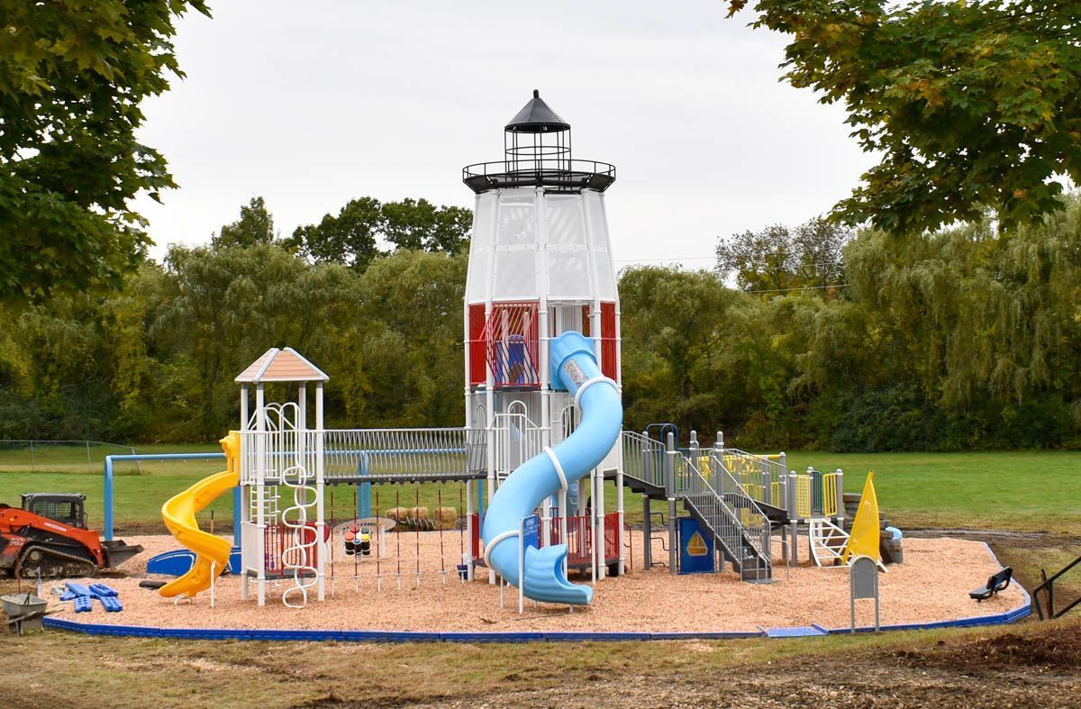 A playground with a lighthouse in the middle of it