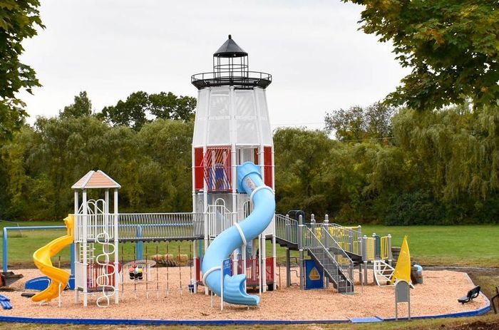 A playground with a lighthouse in the middle of it
