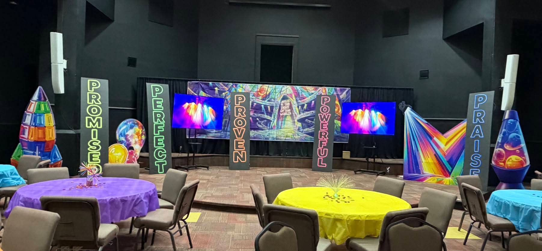 Display of butterflies, magnifying glass, and foliage indoors; butterflies are blue, purple, and orange.