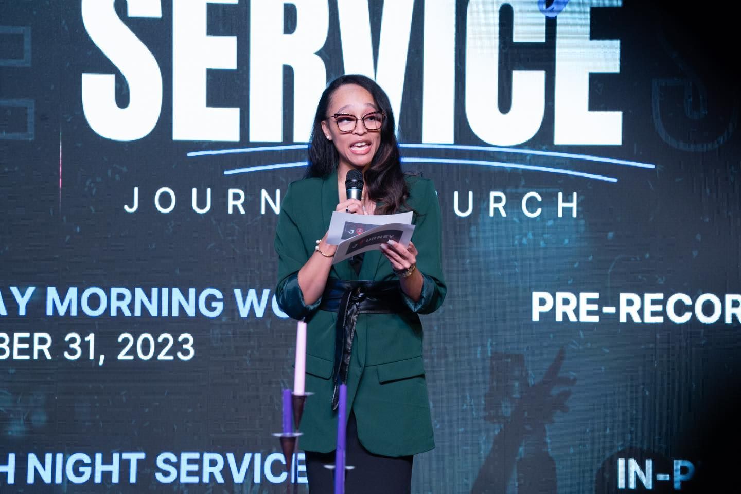 A woman is standing in front of a sign that says service