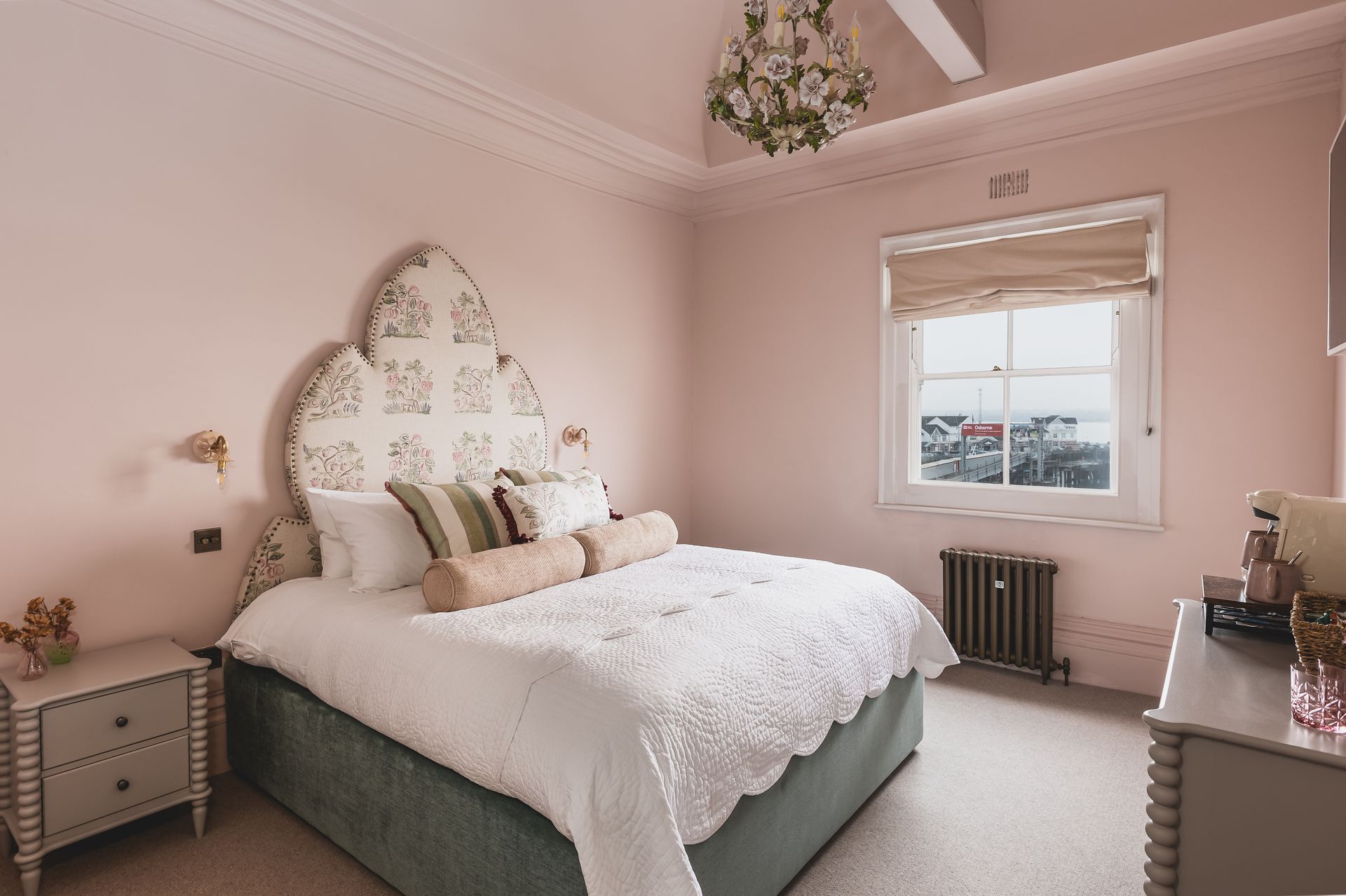 A bedroom with a large bed and a window