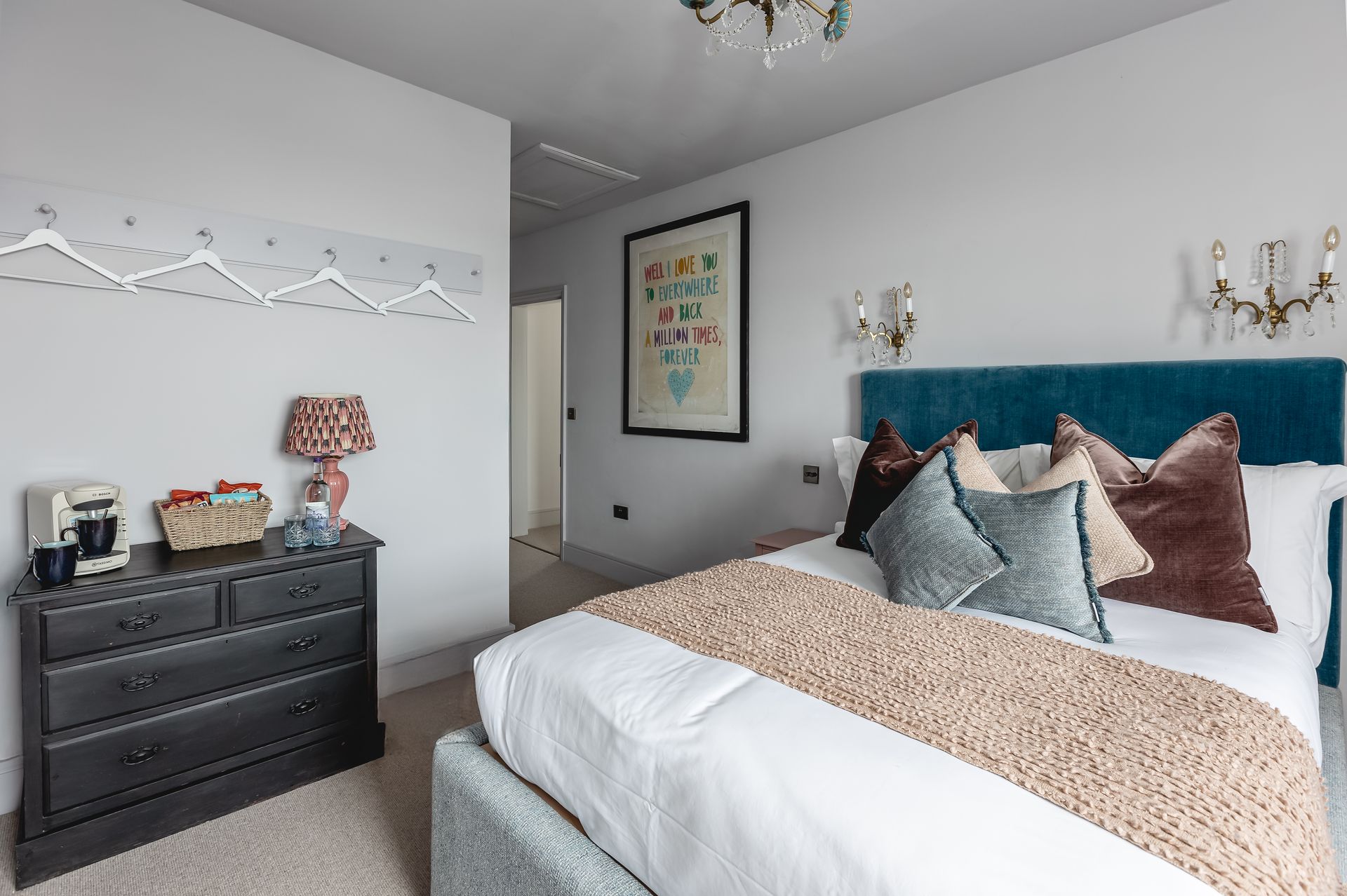 A bedroom with a large bed and a dresser.