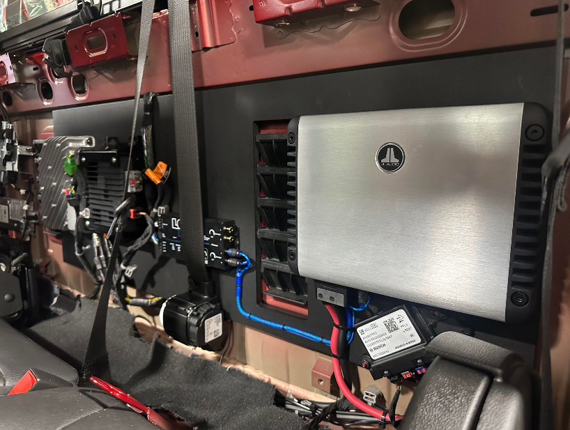 A laptop is sitting on the back of a car.