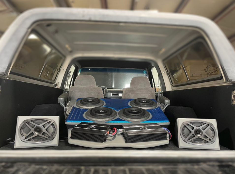 A car with a subwoofer and speakers in the back