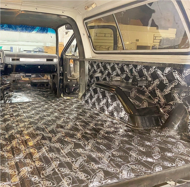 The inside of a truck is covered in black and white foam.