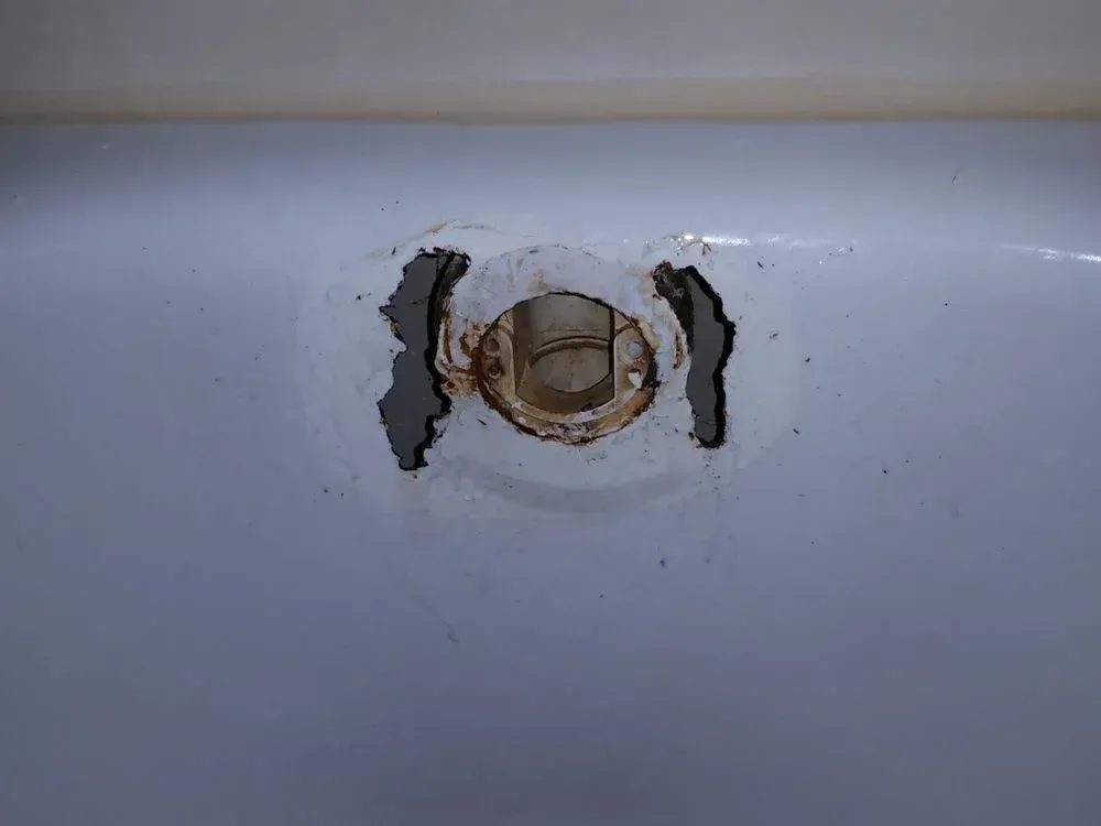 A close up of a sink with a hole in it.