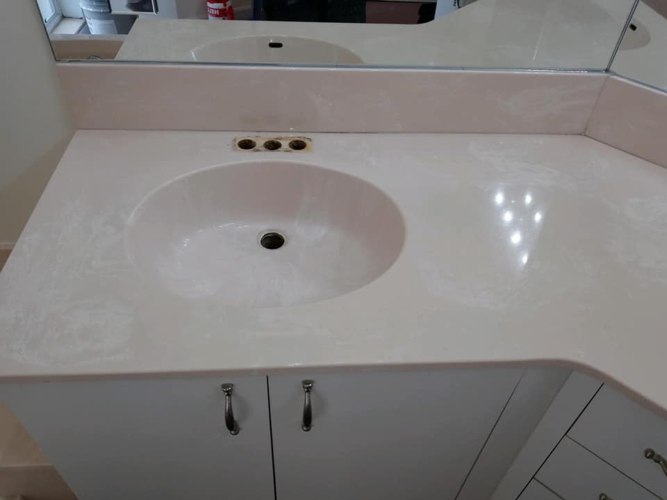 A bathroom counter with a sink and a mirror