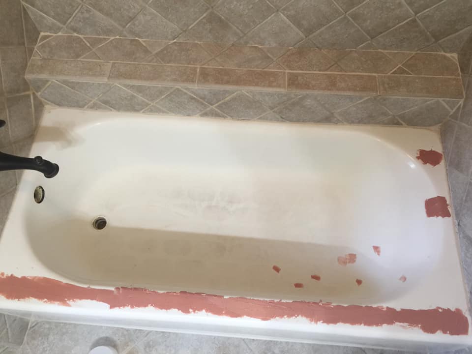 A bathtub is being painted in a bathroom.