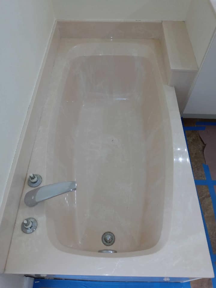 A bathtub is sitting on top of a blue table in a bathroom.