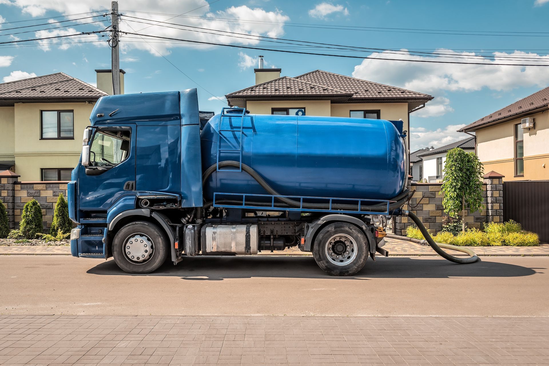 A Blue Tanker Truck Parked on a Residential Street — Tamworth Water Cartage in Duri, NSW