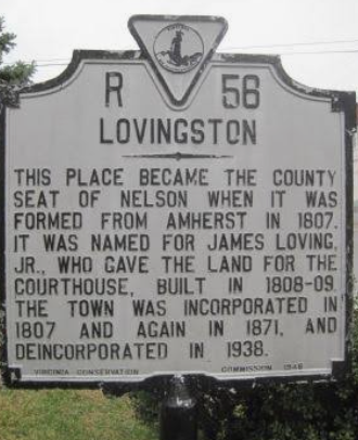 Historic roadside marker for Lovingston, with black text on a weathered white sign. Historic roadside marker for Lovingston, with black text on a weathered white sign.