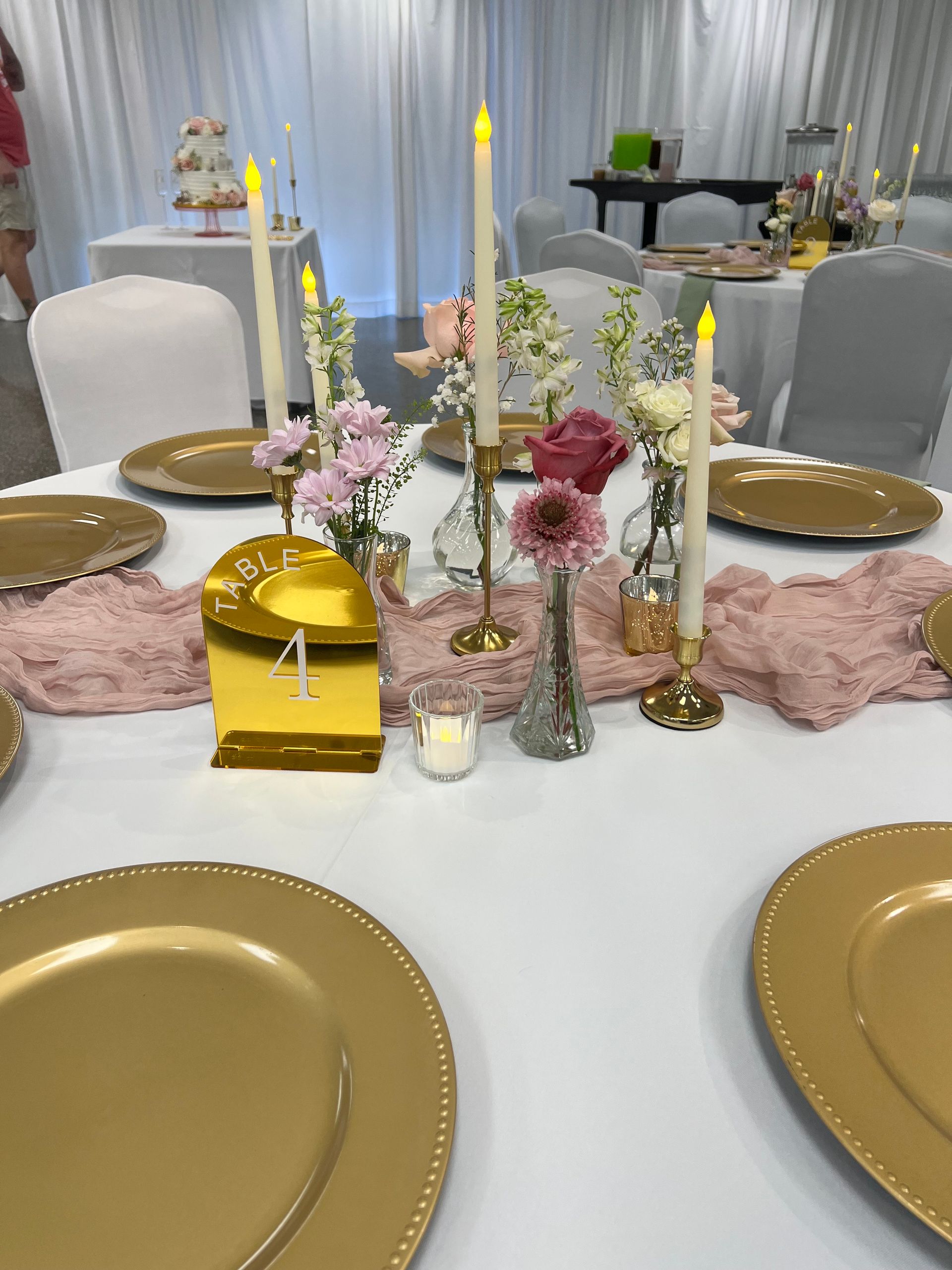 A table with plates , candles and flowers on it