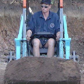 man operating mini excavator
