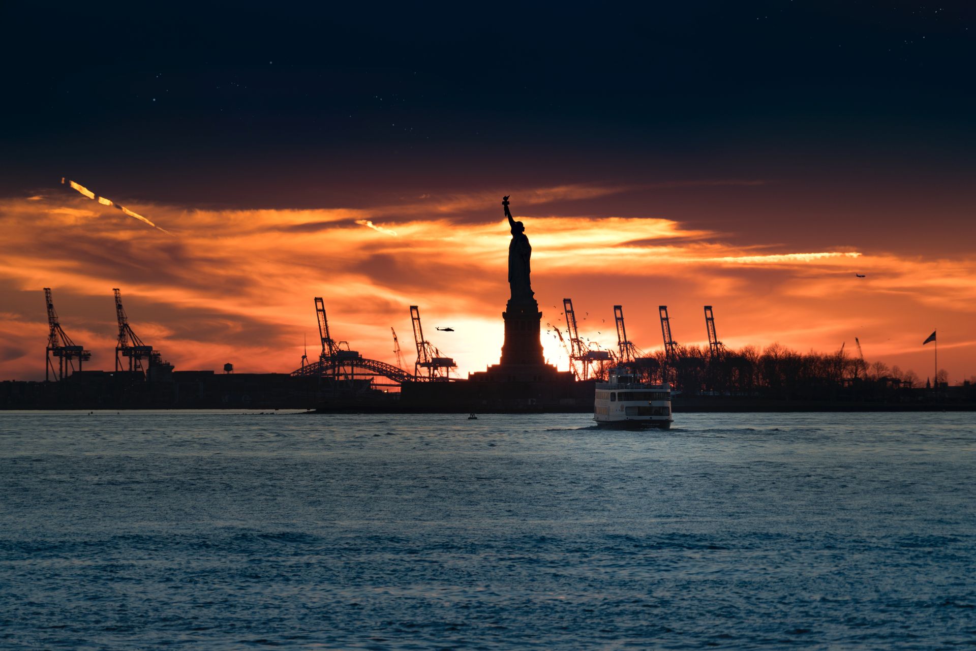 statue of liberty on a beautiful sunset surrounded by the large micro excavator on the gold coast
