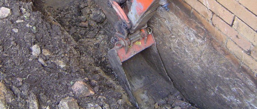 orange excavator bucket digging
