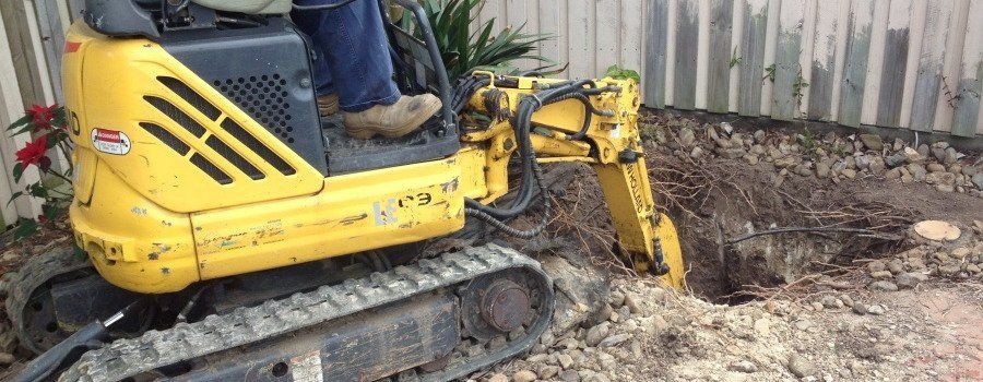man operating yellow excavator digged in