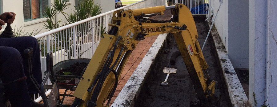 yellow truck excavator with shovel on ground