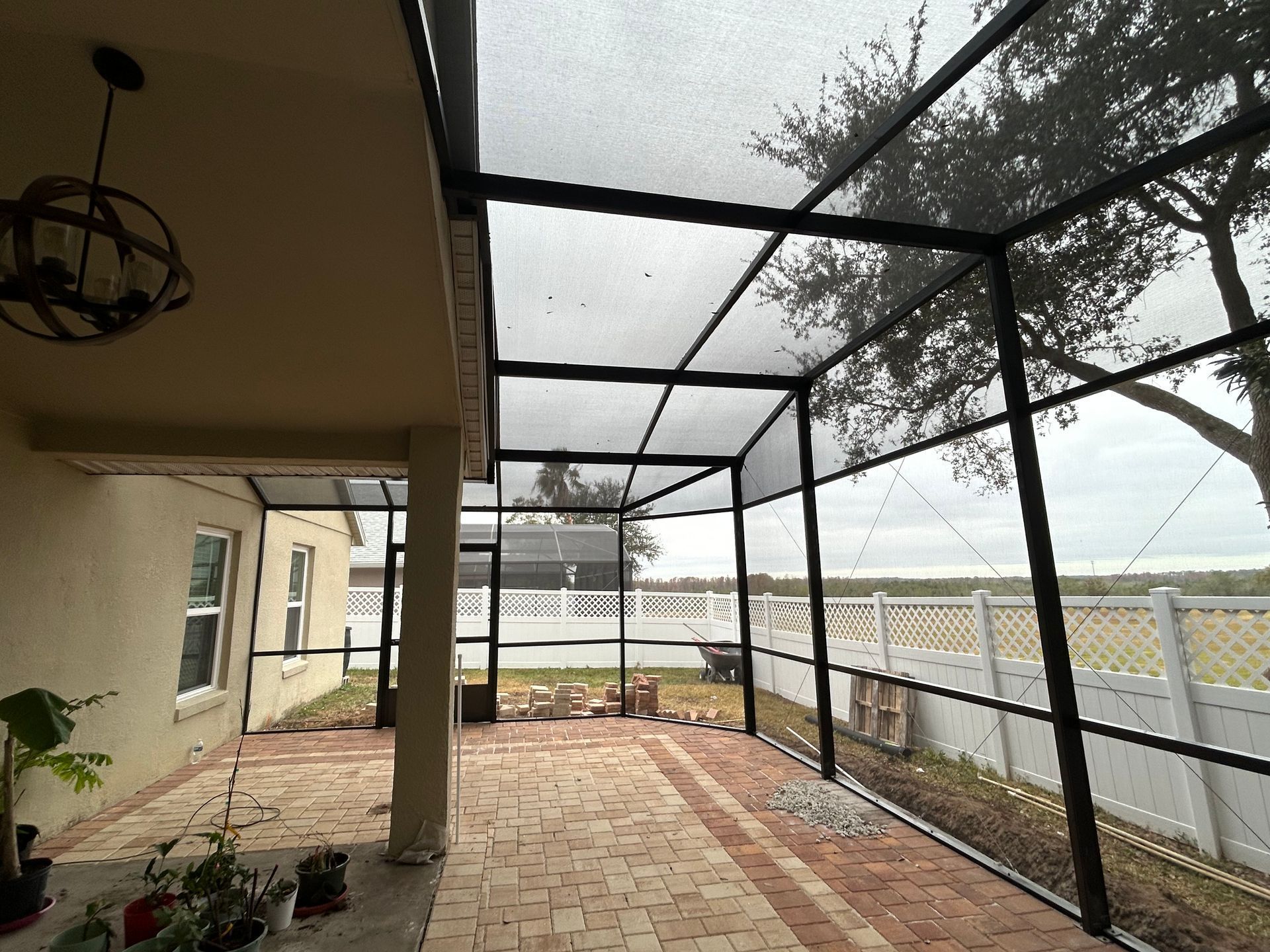 A screened in porch with a view of a lake