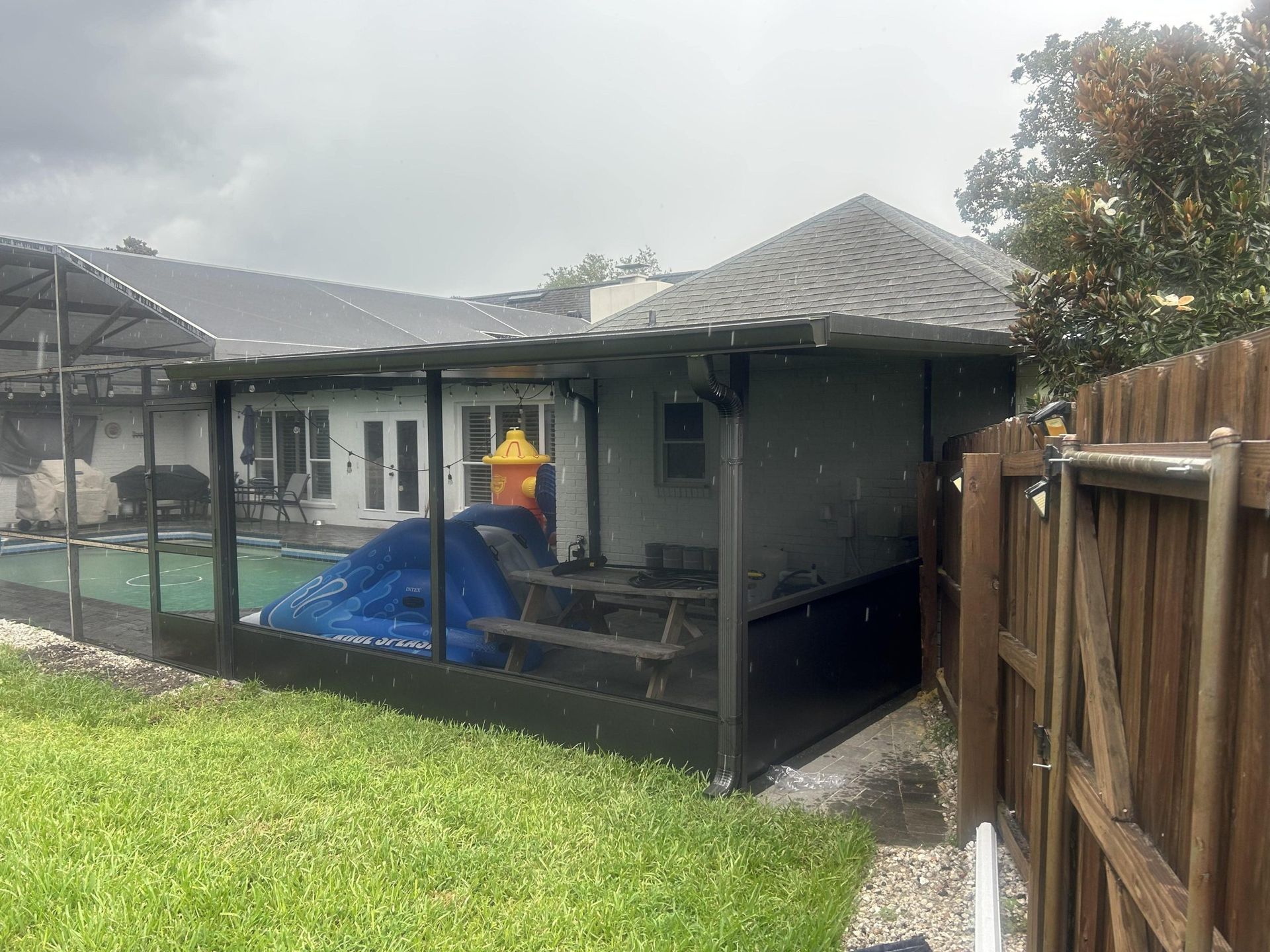 A house with a pool and a fence in the backyard