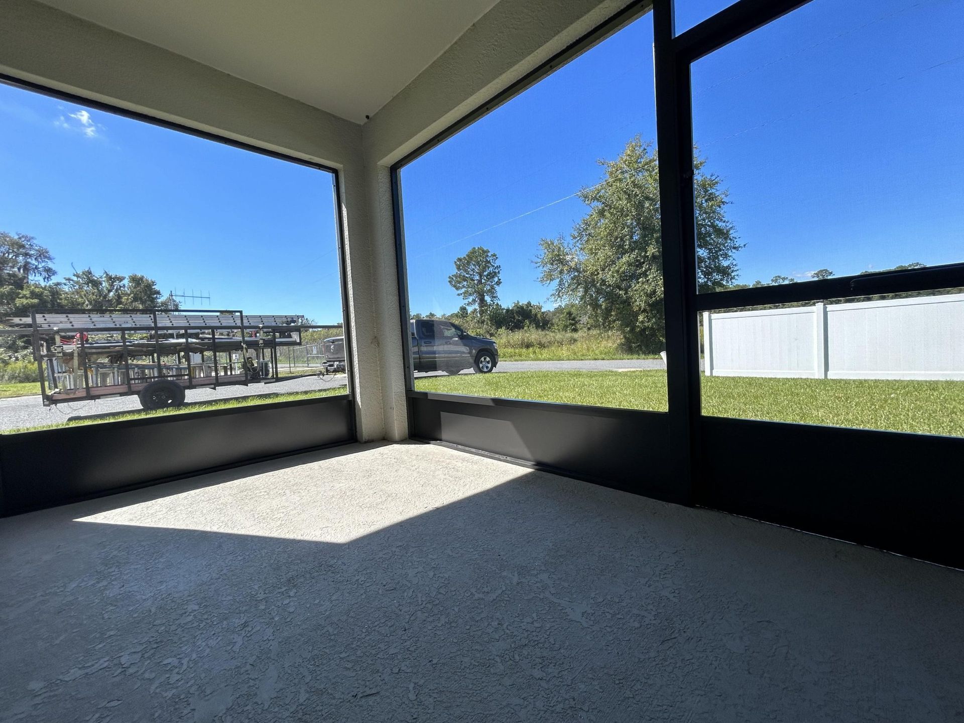 A room with a lot of windows and a truck in the background