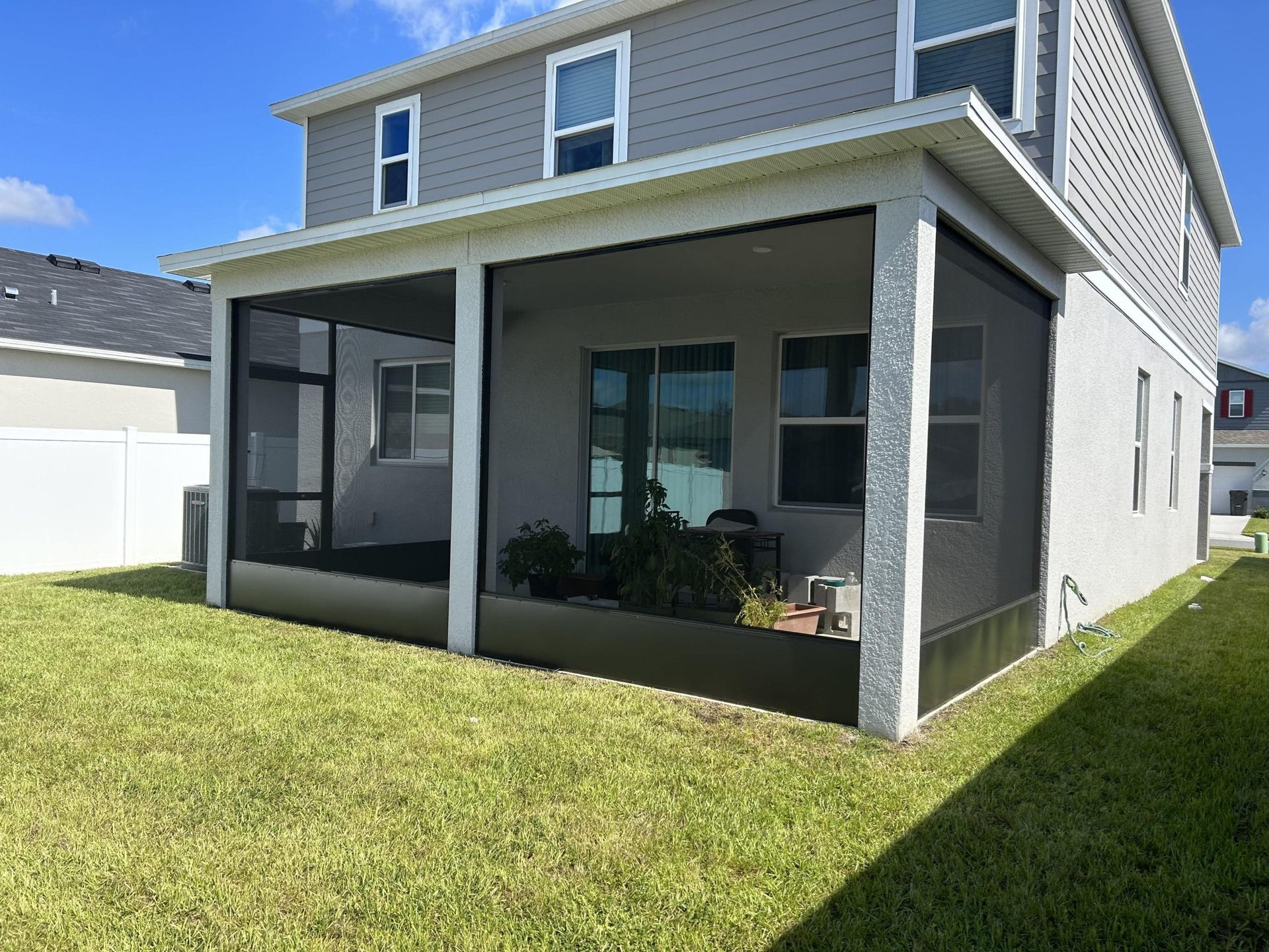 The back of a house with a screened in porch