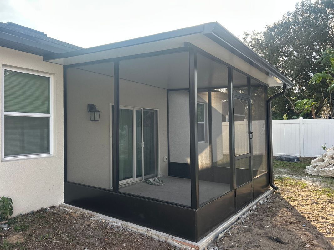 A screened in porch is being built on the side of a house