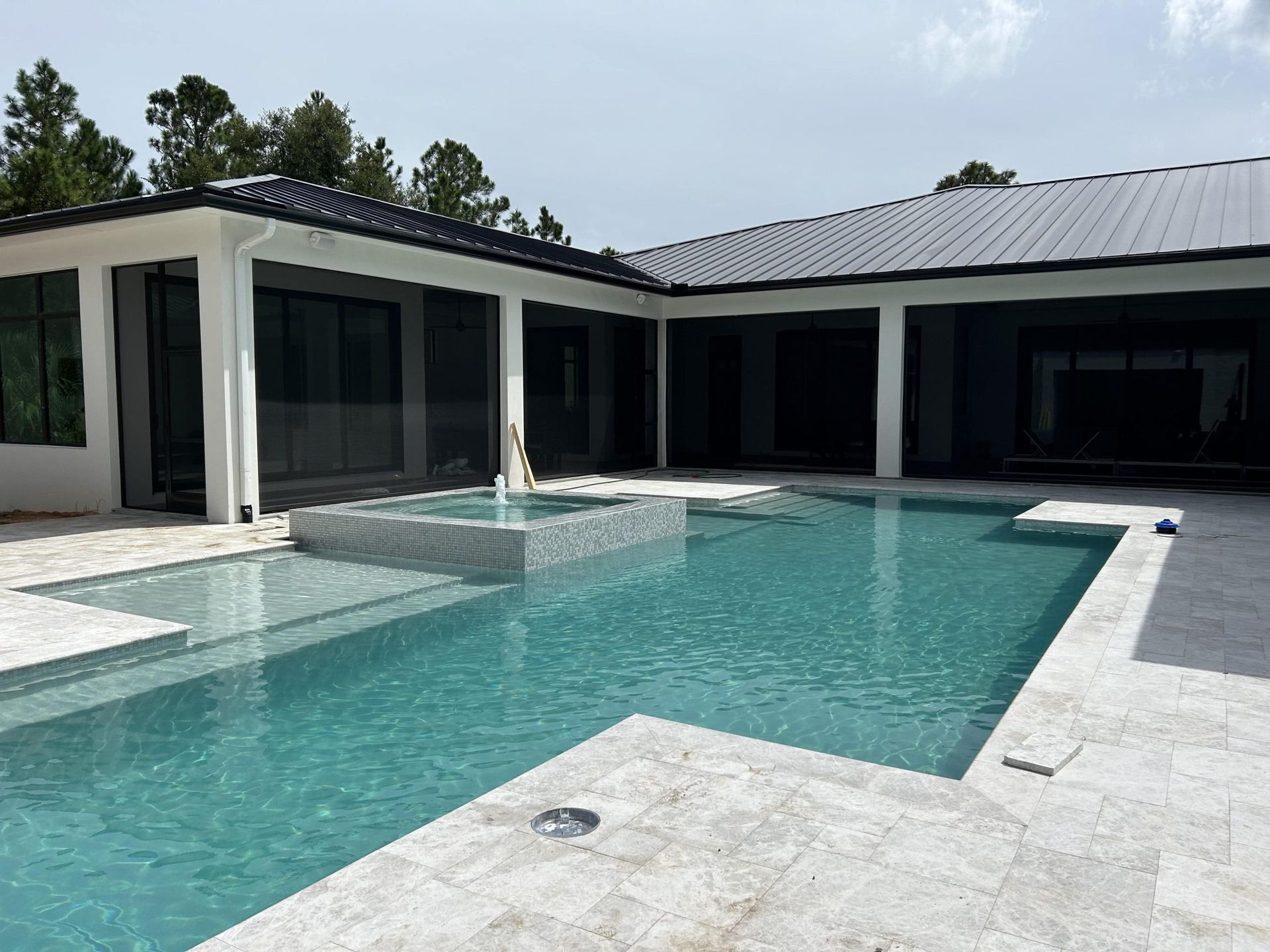 A large house with a large swimming pool in front of it