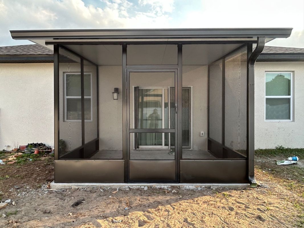 A screened in porch is being built on the side of a house
