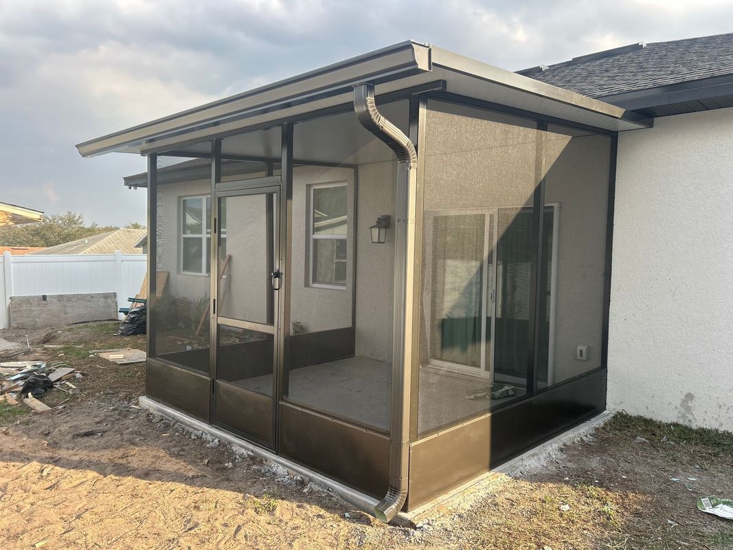 A screened in porch is being built on the side of a house