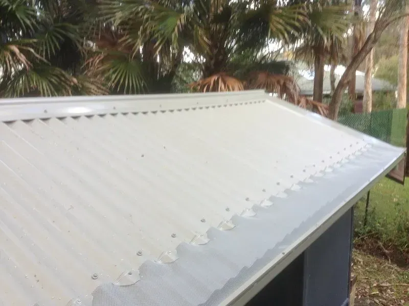 A Close Up of a Gutter With a Mesh Cover on It — Coast Metal Roof & Gutter In Tumbi Umbi, NSW