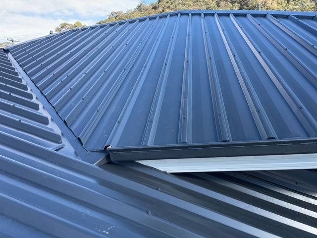 A Close Up of a Gutter With a Mesh Cover on It — Coast Metal Roof & Gutter In Tumbi Umbi, NSW
