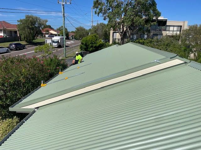 A Close Up of a Gutter on the Side of a Brick Building — Coast Metal Roof & Gutter In Lake Macquarie, NSW