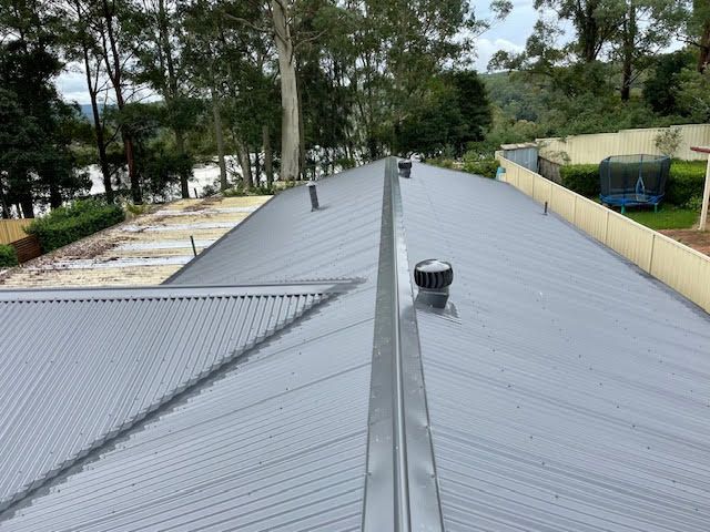 A Roof With a Stainless Steel Ventilator on It — Coast Metal Roof & Gutter In Tumbi Umbi, NSW