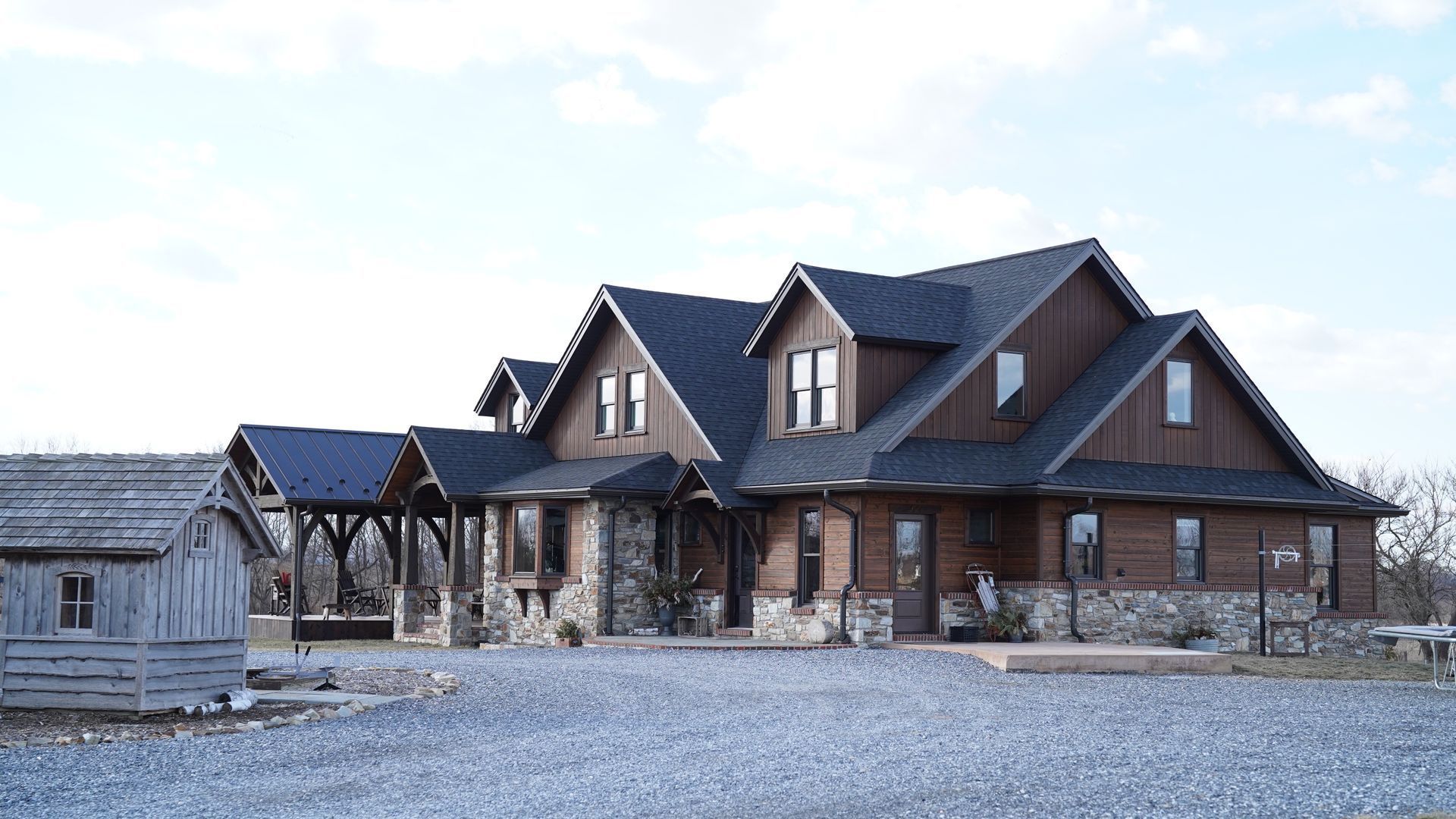 A dog is standing in front of a sliding glass door