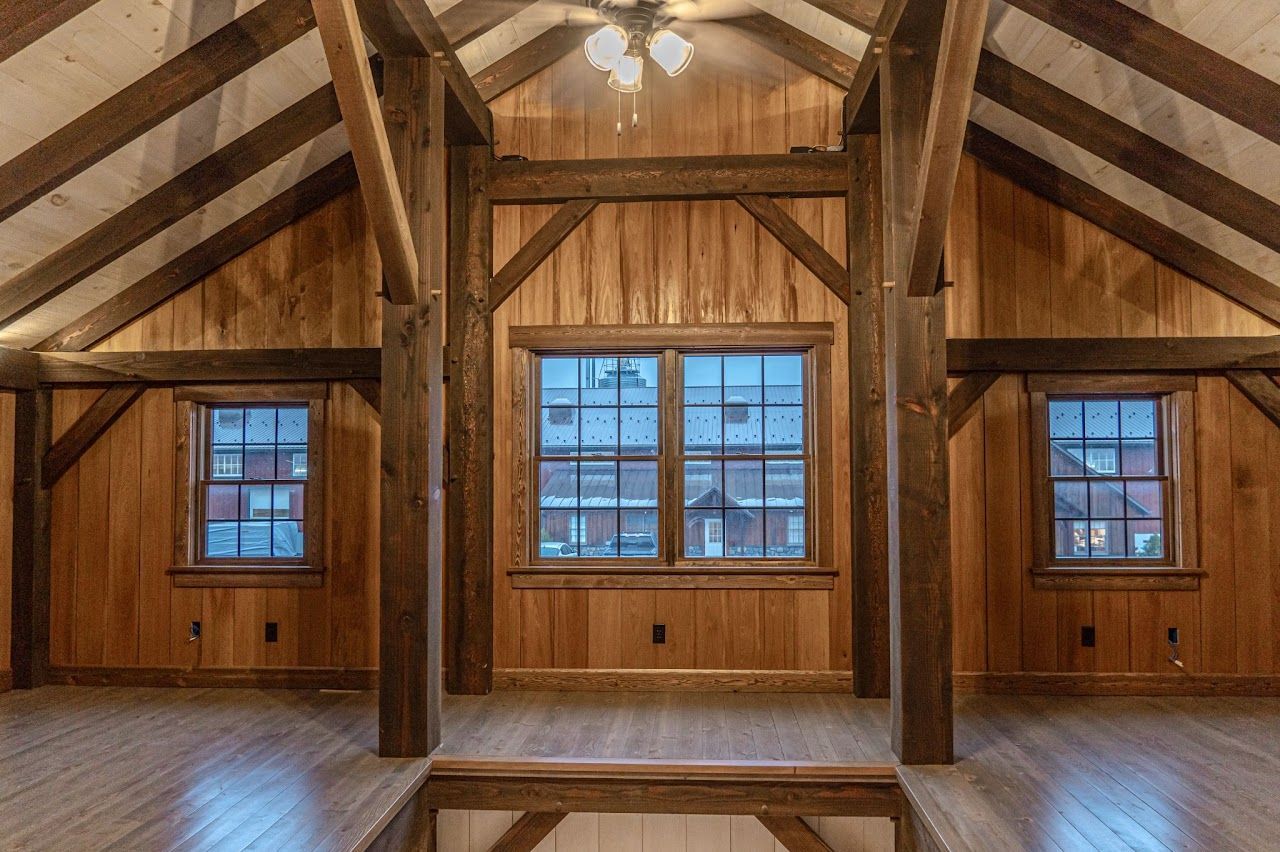 Wooden interior with exposed beams, windows, and light fixture.| Rebuck, PA | Expressions Carpentry