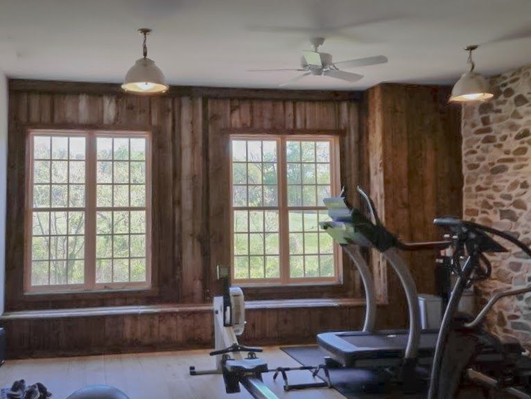 A kitchen with white cabinets and a large island in the middle.