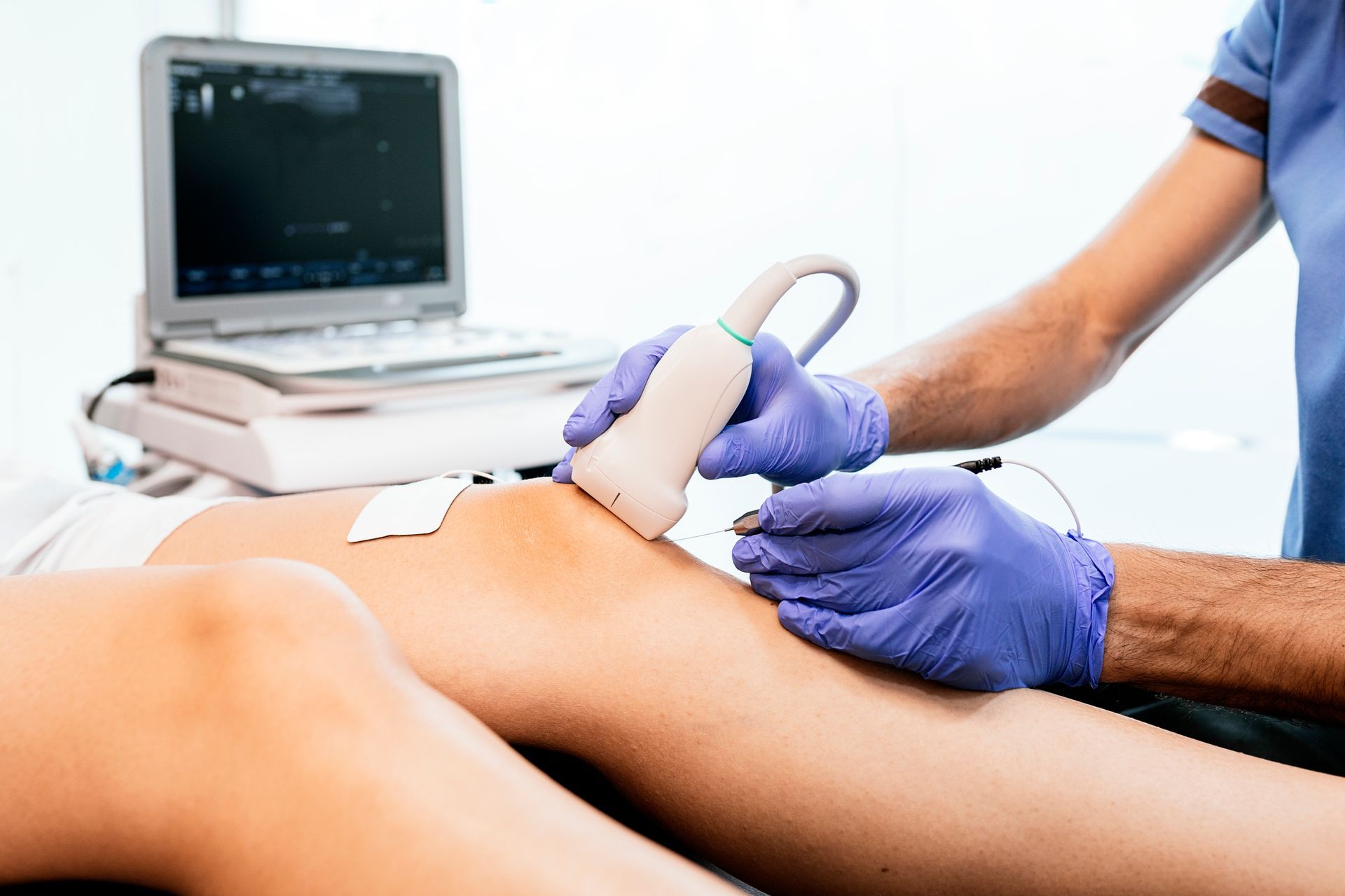 A person is getting an ultrasound on their knee.