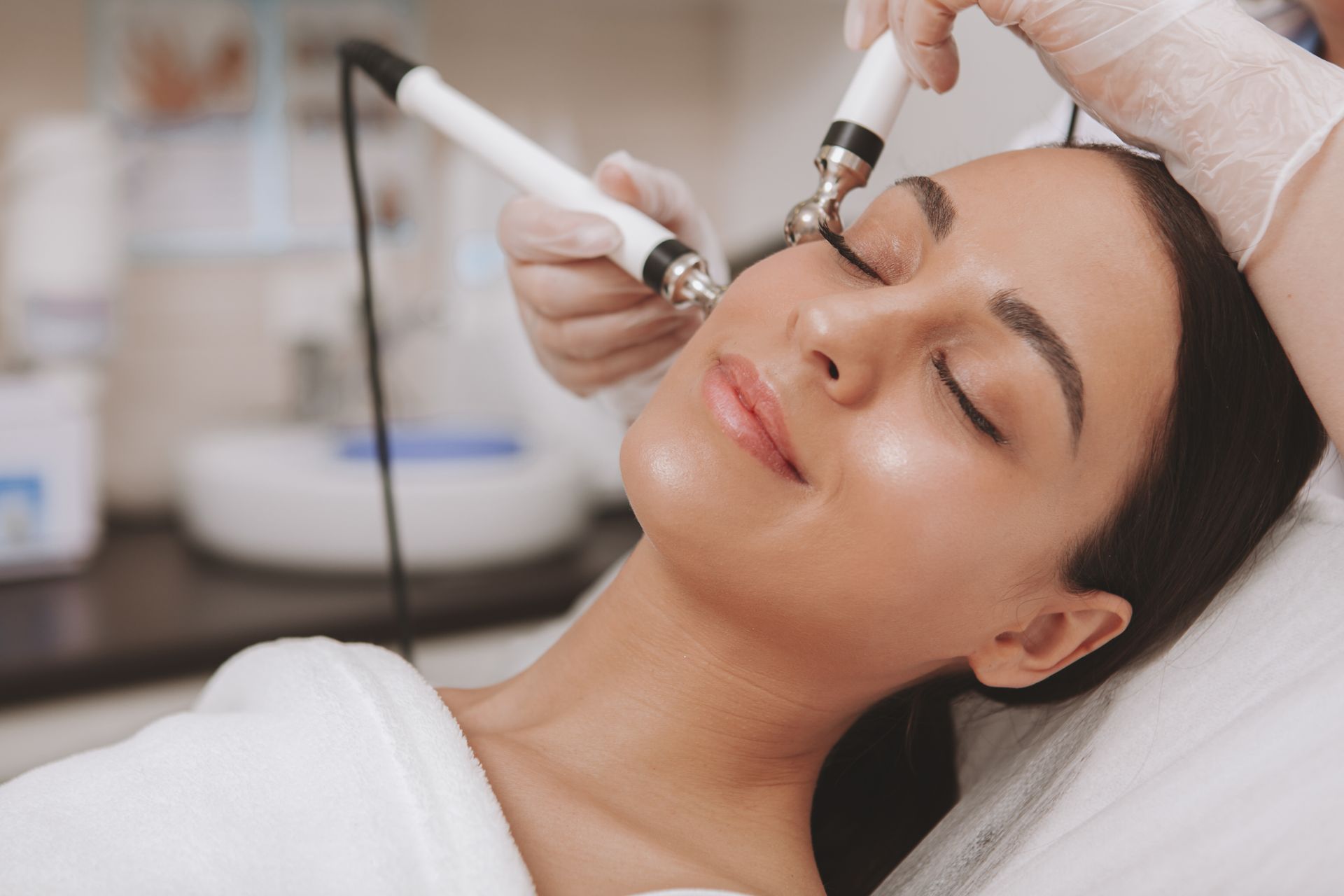 A woman is getting a facial treatment at a beauty salon.
