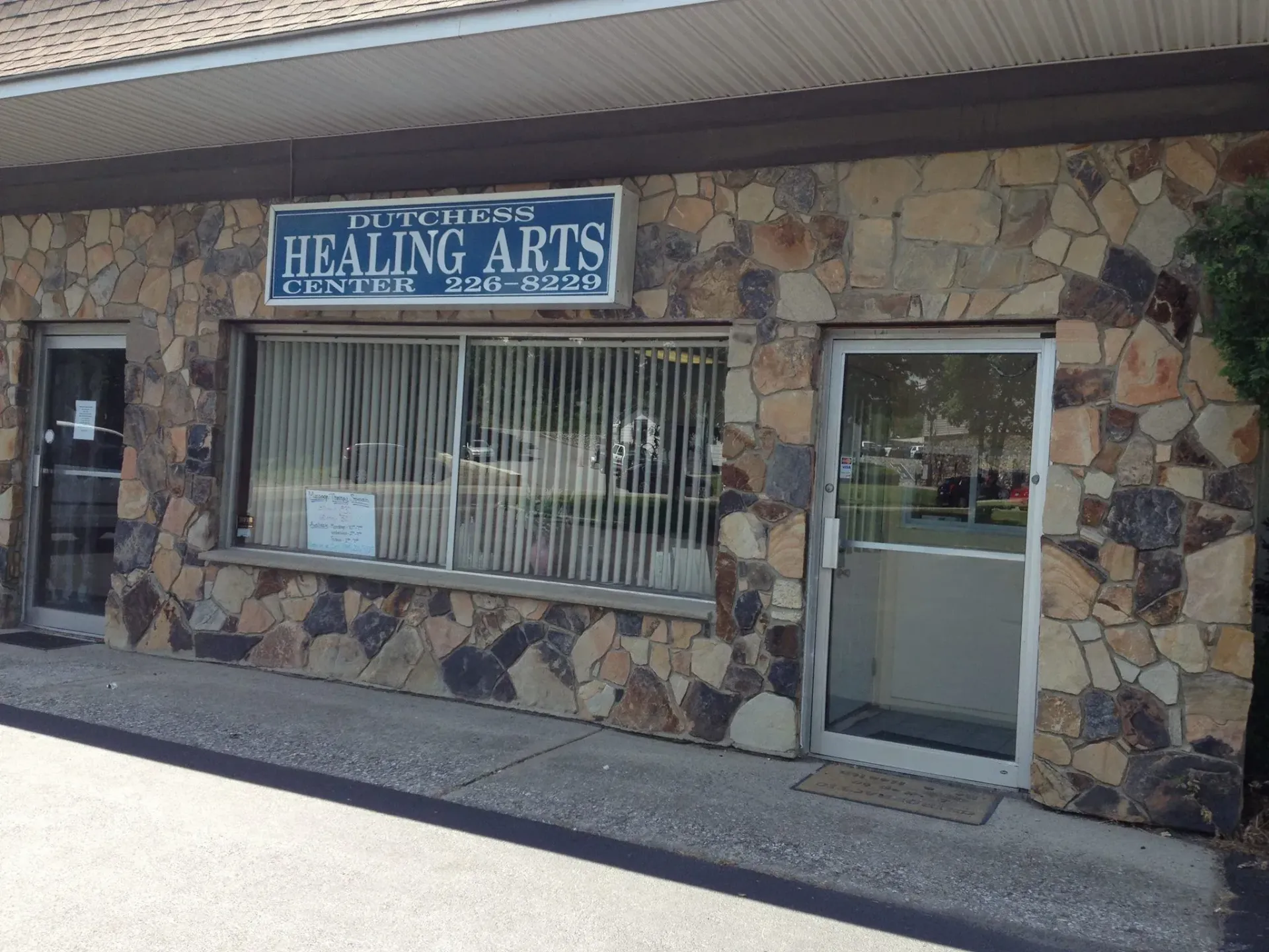 A stone building with a sign that says healing arts