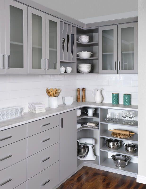 a kitchen with a mixer and bowls on the shelves