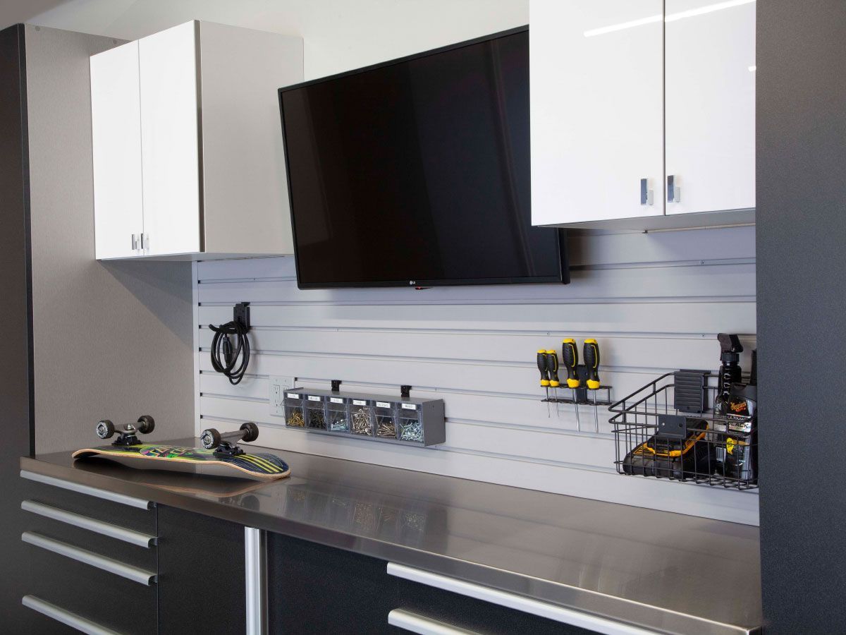 a skateboard is sitting on a workbench in a garage .