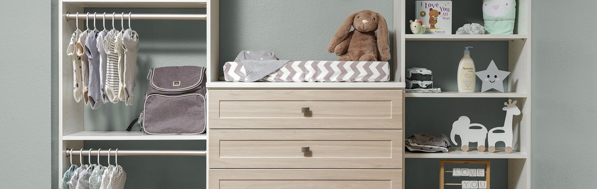 A nursery with a dresser , shelves , and a changing table.