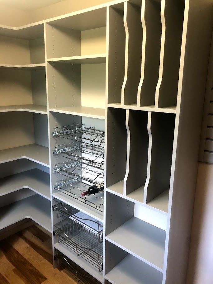 a closet with lots of shelves and a wine rack