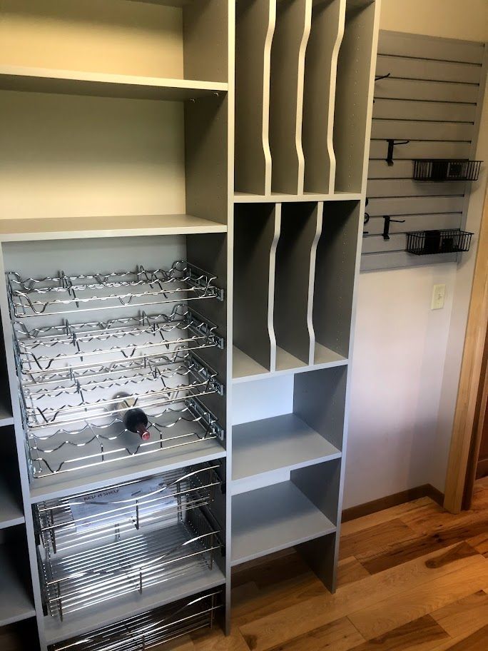 a closet with lots of shelves and a wine rack