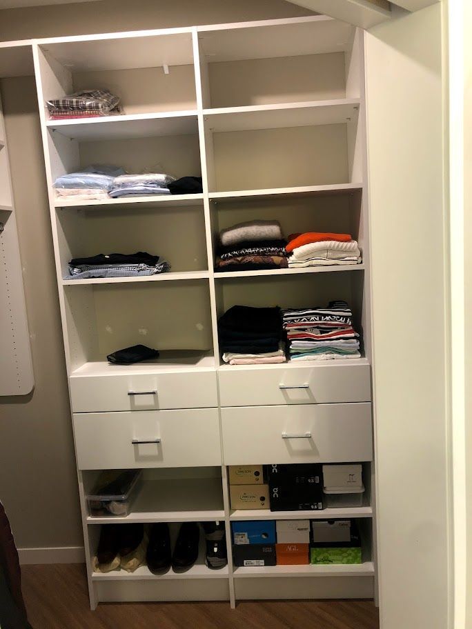 a walk in closet filled with lots of clothes and shoes .