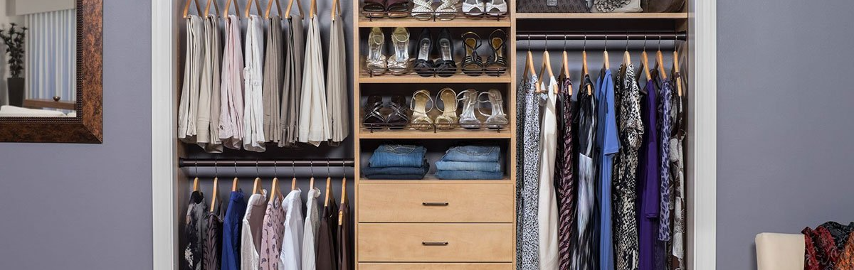 organized custom reach-in closet system filled of shoes, dress  and pants