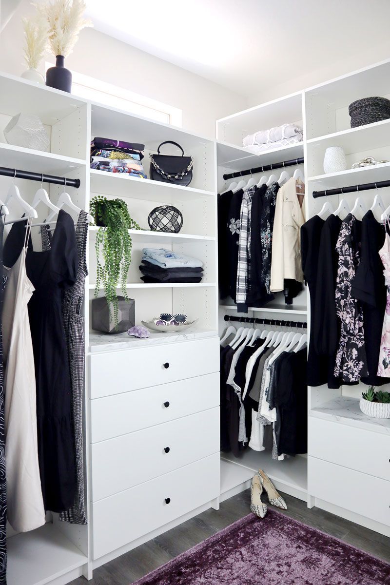 a walk in closet filled with lots of clothes and shoes .