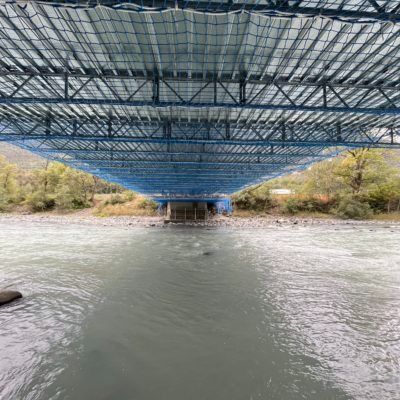 La parte inferiore di un ponte sopra un fiume.